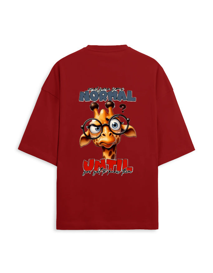 A red oversized short-sleeve t-shirt with a large graphic print on the back. The graphic features a cartoon giraffe wearing round glasses, with the text 'are you normal?' above and 'UNTIL' below in red and white.