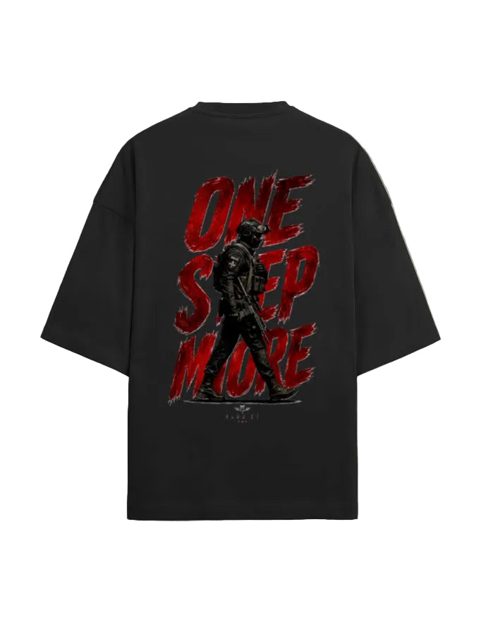 A black oversized t-shirt shown from the back, featuring a large graphic print with the words 'ONE STEP MORE' in distressed red lettering and a dark soldier silhouette.