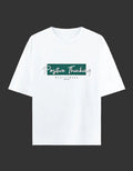 A white short-sleeve crewneck t-shirt with a graphic on the chest that reads 'Positive Thinking' in white script over a dark green rectangular block, with 'STAY STRONG' printed below in small black letters, displayed on a light cream background.