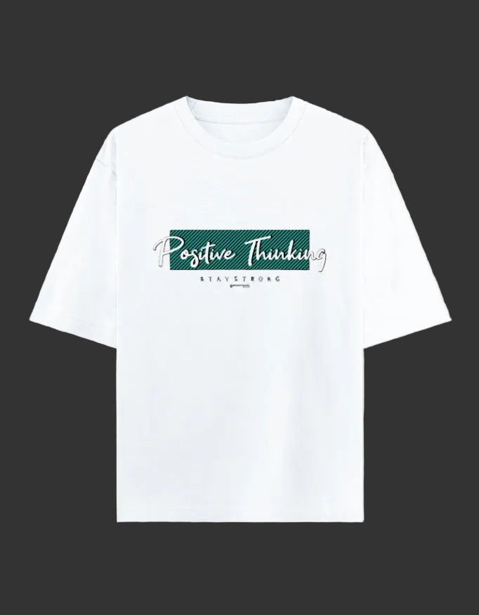 A white short-sleeve crewneck t-shirt with a graphic on the chest that reads 'Positive Thinking' in white script over a dark green rectangular block, with 'STAY STRONG' printed below in small black letters, displayed on a light cream background.