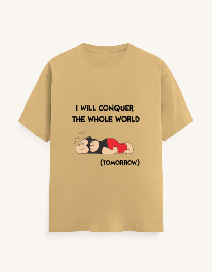 Front view of a mustard-colored unisex classic crew neck t-shirt featuring a sleeping cartoon monkey and the text "I WILL CONQUER THE WHOLE WORLD (TOMORROW)" printed on the center chest.