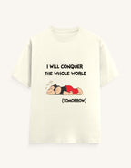 Front view of a mustard-colored unisex classic crew neck t-shirt featuring a sleeping cartoon monkey and the text "I WILL CONQUER THE WHOLE WORLD (TOMORROW)" printed on the center chest.