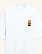Front view of a premium white unisex terry oversized t-shirt featuring a small cartoon character graphic on the left chest pocket area.