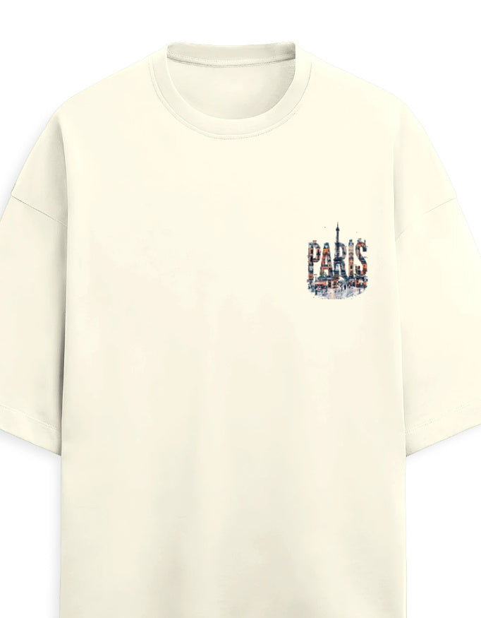An off-white short-sleeve crewneck t-shirt featuring a small graphic on the left chest that spells 'PARIS' in a collage of Parisian landmarks, including the Eiffel Tower.
